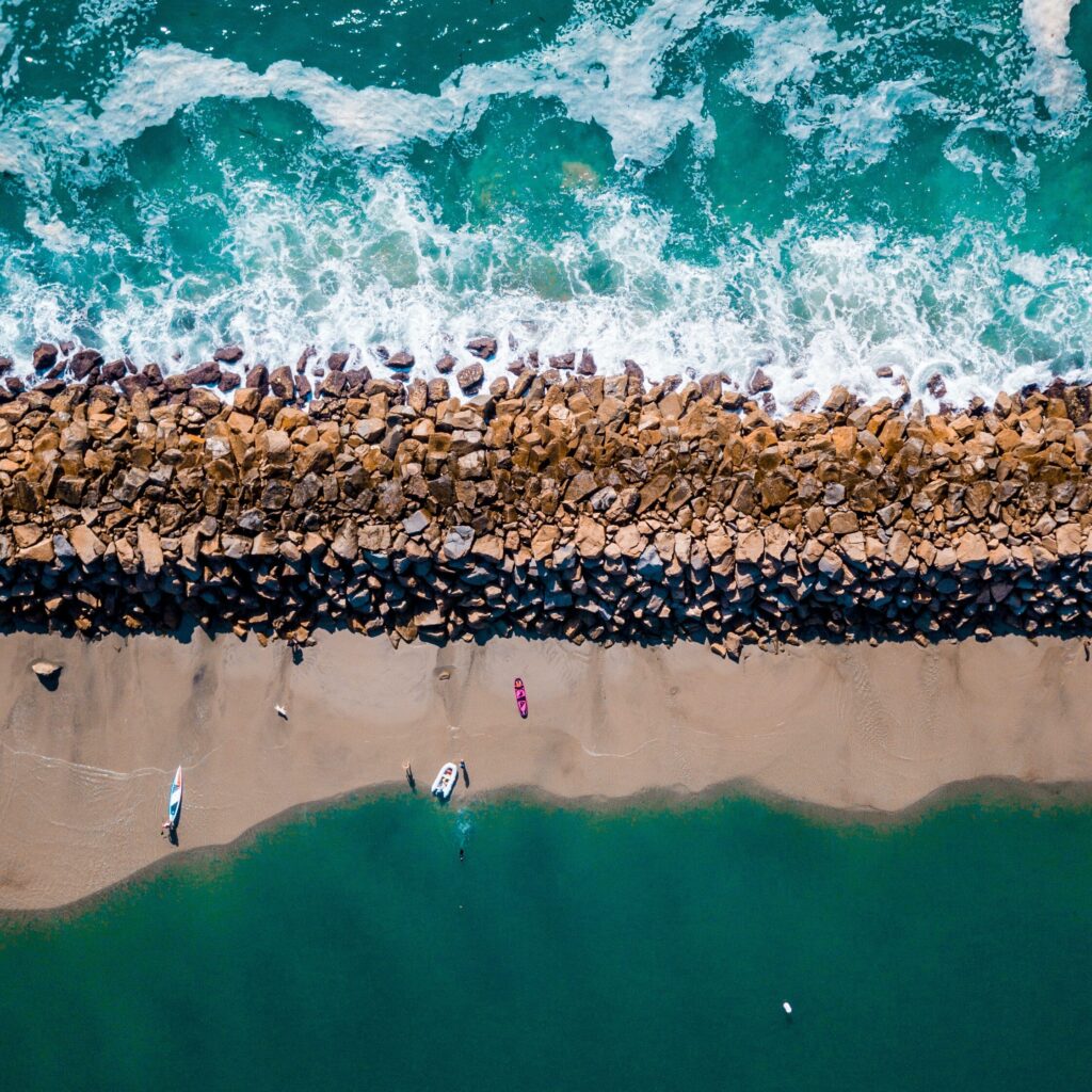 a jetty with waves crashing against it